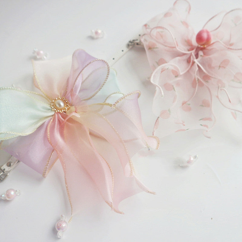 Dainty pastel bows with pearls, perfect for adorable pet accessories or crafting embellishments.
