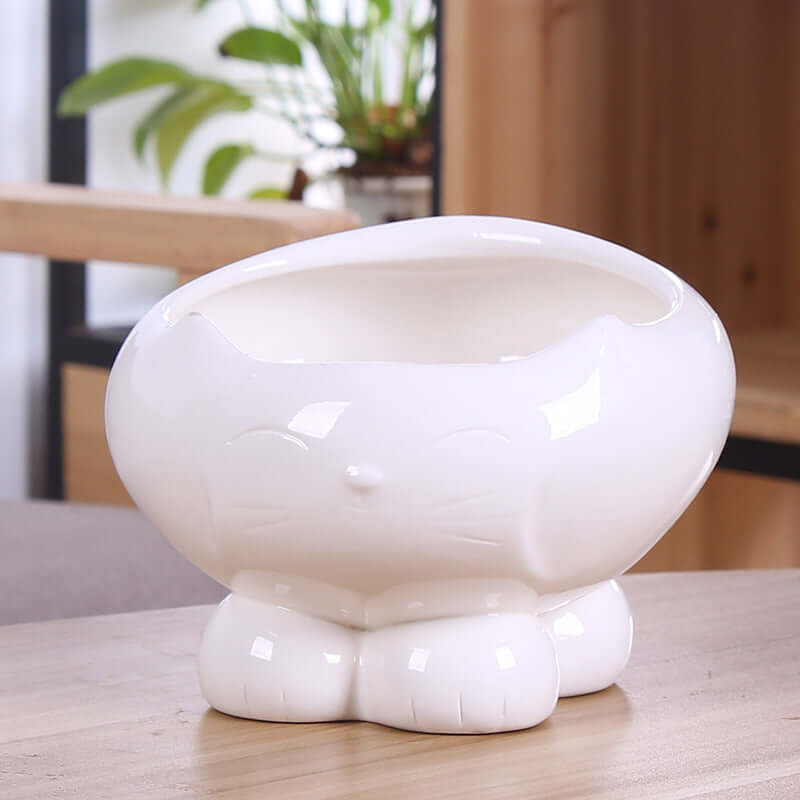 Distributeur de nourriture et d'eau pour chat en résine blanche, design moderne et pratique pour animaux.