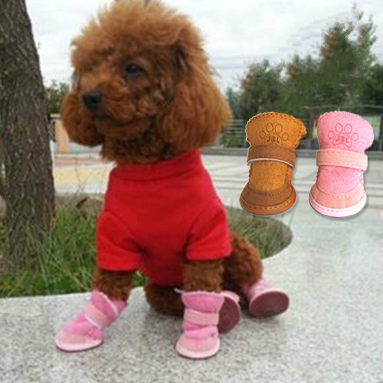 Poodle wearing red outfit and pink snow boots for dogs, showcasing comfort and style.