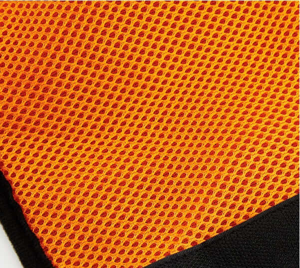 Textured orange mesh fabric close-up, ideal for pet harnesses and comfort accessories.