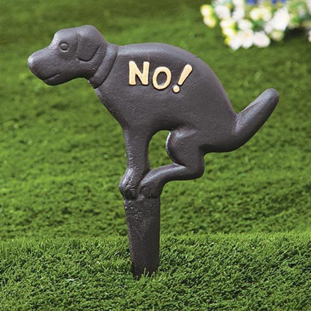 Iron dog lawn insert with 'NO!' message for pet-friendly garden decor.
