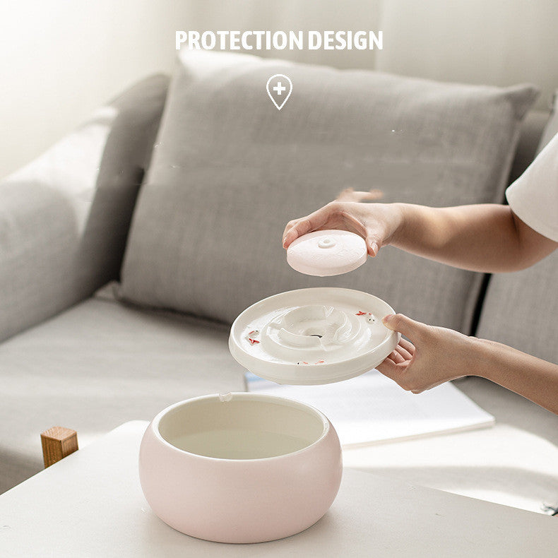Person demonstrating the protection design of a ceramic automatic pet water fountain, highlighting its functionality.