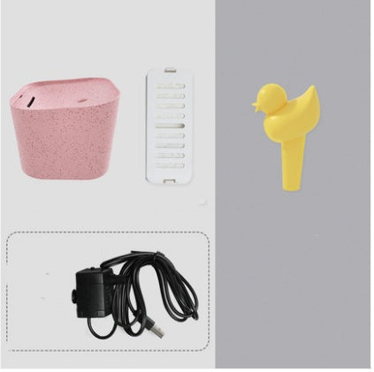 Distributeur d'eau automatique pour chats avec accessoires et adaptateur, couleur rose et jaune.