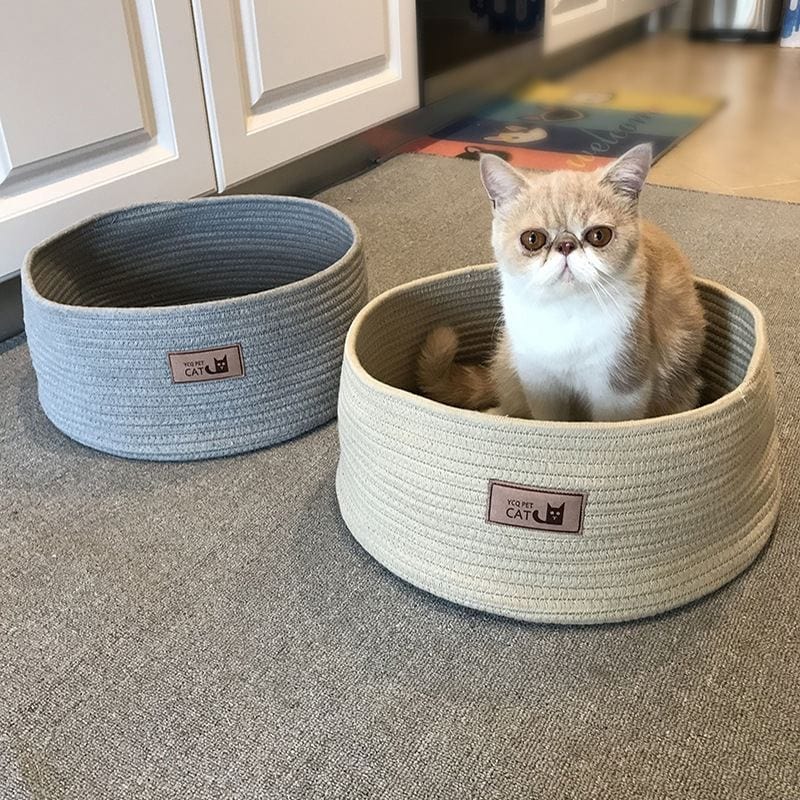 Charming cat resting in a handmade cotton rope bed, with a gray and beige option, showcasing eco-friendly pet accessories.