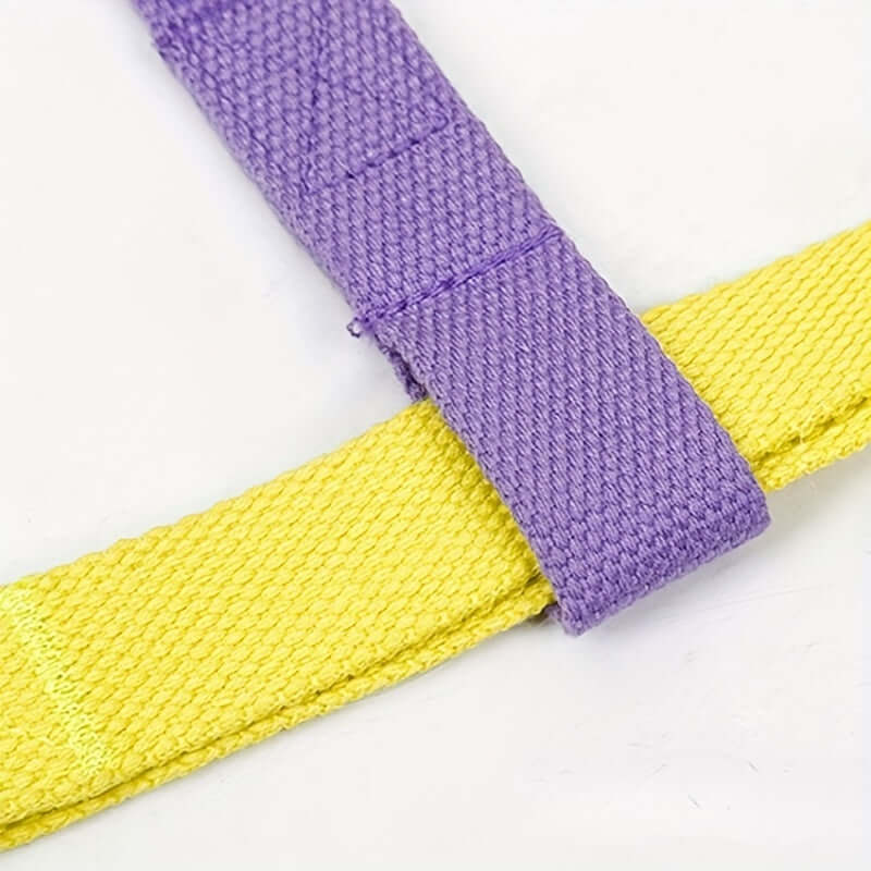 Close-up of a colorful anti-escape dog harness in purple and yellow durable fabric, highlighting safety features.
