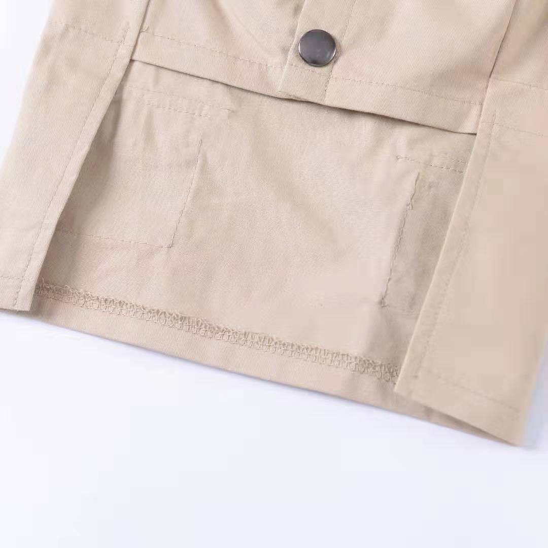 Close-up of a beige dog sweater with two pockets and button detail for enhanced style and comfort.