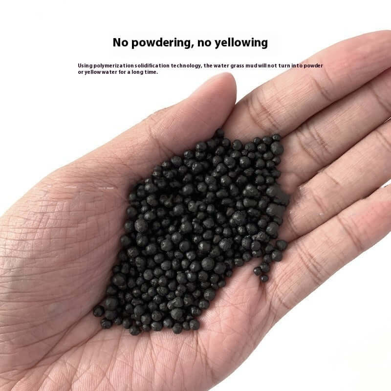 Main hand holding black aquarium substrate, showcasing its no dust, no yellowing features for aquatic environments.