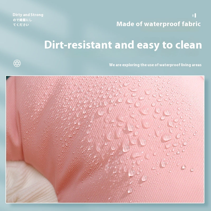 Close-up of waterproof fabric showcasing dirt-resistant features with water droplets on a pink surface.