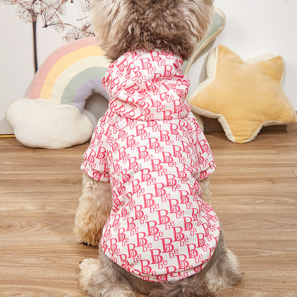 Cute dog wearing a pink letter print hoodie sweater, suitable for pets, made of soft polyester, cozy and stylish.