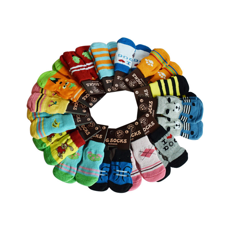 Colorful collection of dog socks arranged in a circular pattern, featuring various playful designs and patterns.