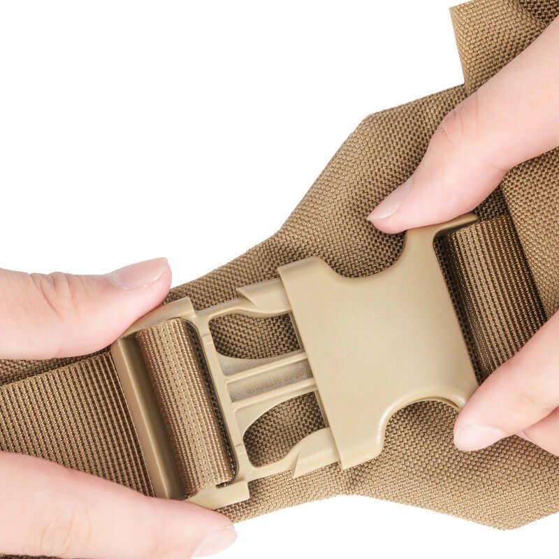 Close-up of hands fastening the buckle of a tactical dog backpack in a robust design.