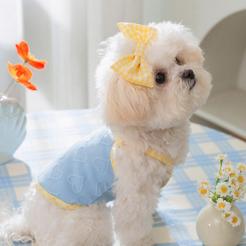 Charming small dog in textured heart salopette with bow, featuring Bundy Blue color and comfortable design.