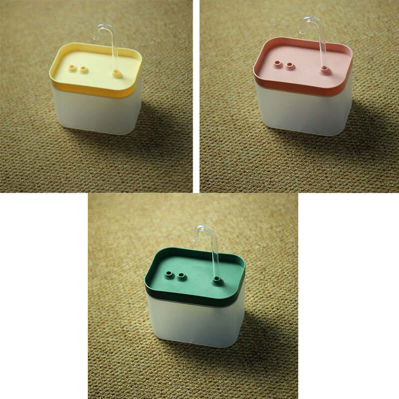 Distributeur automatique d'eau pour animaux, disponible en trois couleurs : jaune, rose et vert.