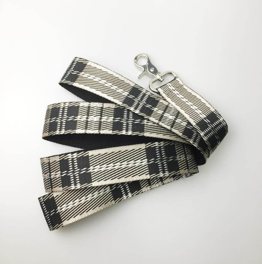 Laisse pour chien en nylon avec motif à carreaux noir et blanc, idéale pour promenades et confort.