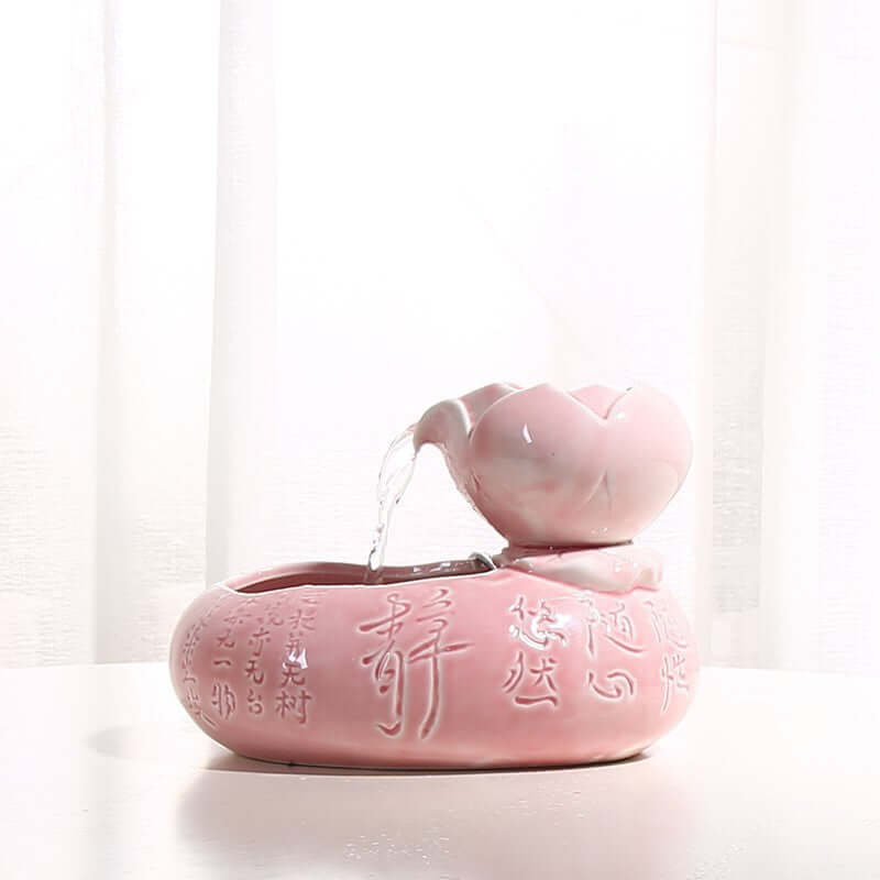Distributeur de nourriture et d'eau pour chat en résine rose, élégant et pratique pour garder votre félin hydraté.