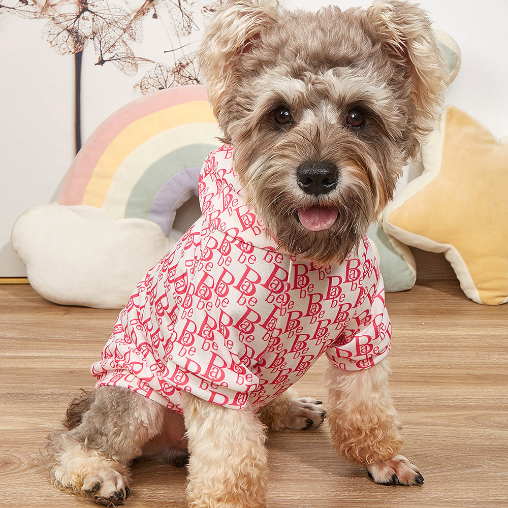 Dog wearing a pink letter print hoodie, showcasing stylish pet clothing for animals, perfect for casual outings.