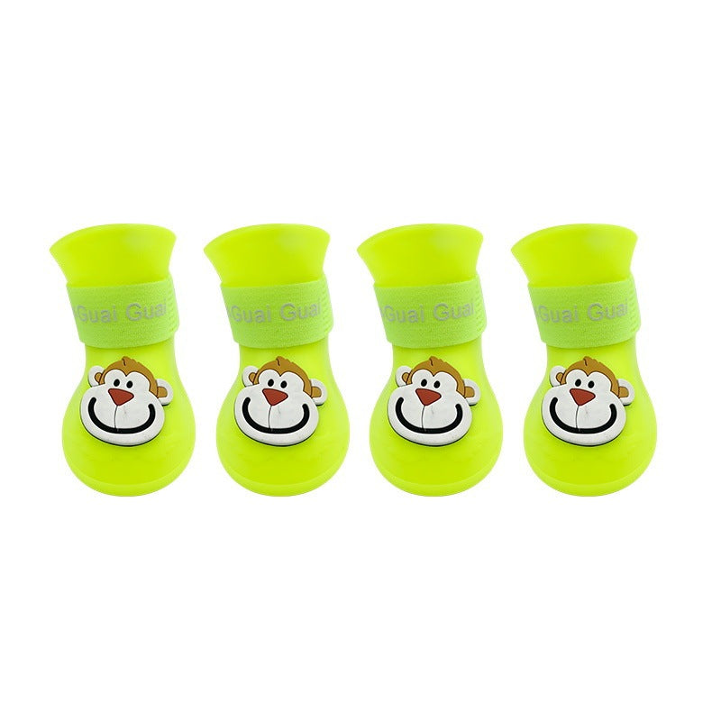 Bottes en silicone antidérapantes jaunes pour animaux avec motif de singe, offrant confort et protection.