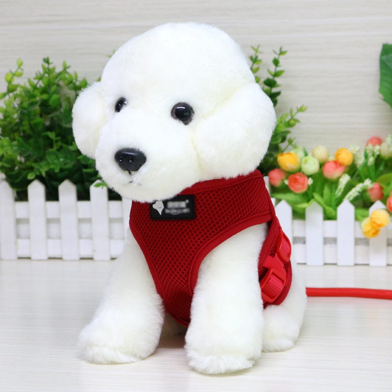 Charming plush toy dog wearing a red mesh harness, perfect for walks and pet accessories.