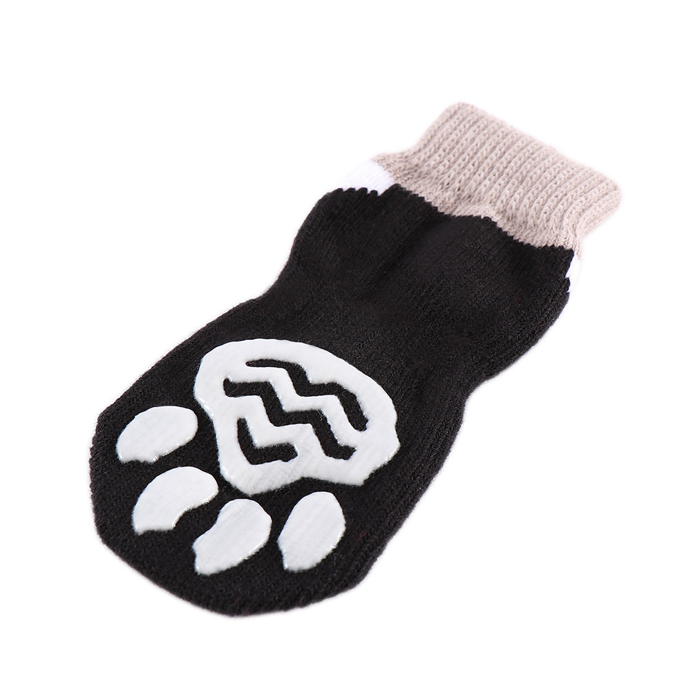 Chaussette antidérapante noire pour animaux avec motif de patte, idéale pour le confort des chiens et chats.