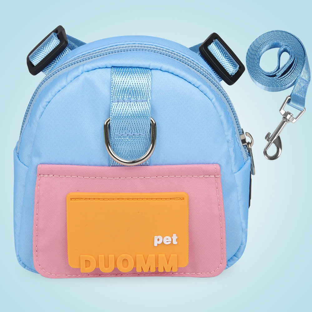 Sac à dos multifonction pour chiens, bleu avec poche rose et sangle, idéal pour les aventures en plein air.