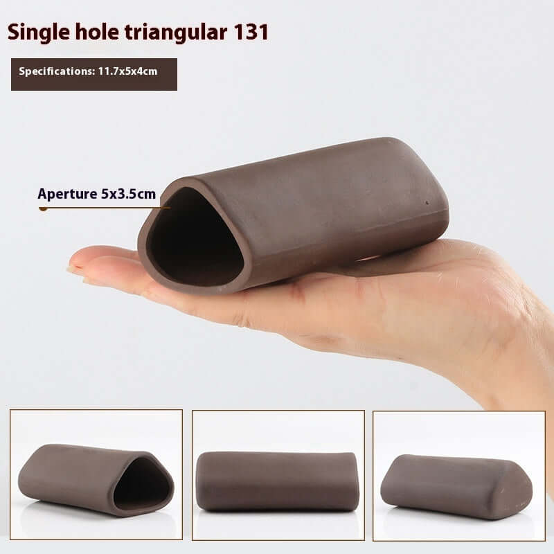 Single hole triangular decoration for aquariums, made of brown material and designed for aquatic landscapes.