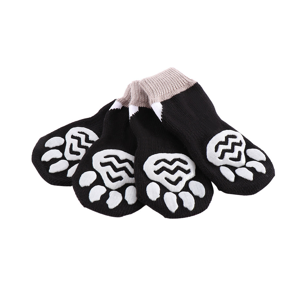 Chaussettes intérieures pour animaux de compagnie, conçues avec des pattes anti-dérapantes en noir et blanc.