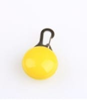Clip-on yellow LED light accessory for pet safety during night walks.