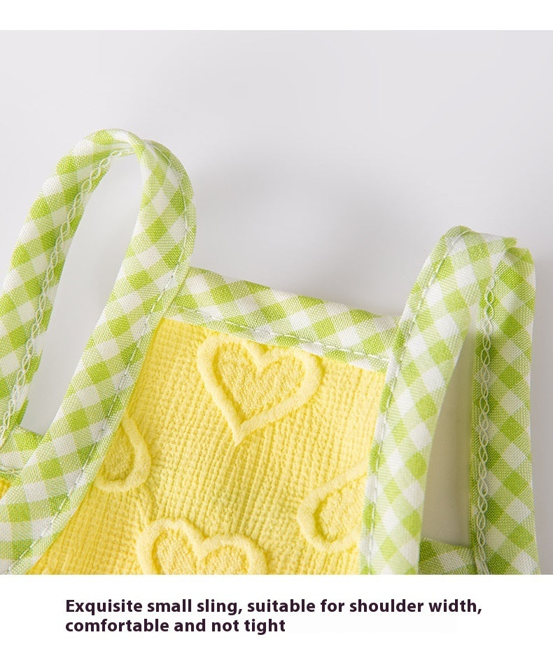 Small yellow sling with green checkered straps and heart design, perfect for pet comfort and style.