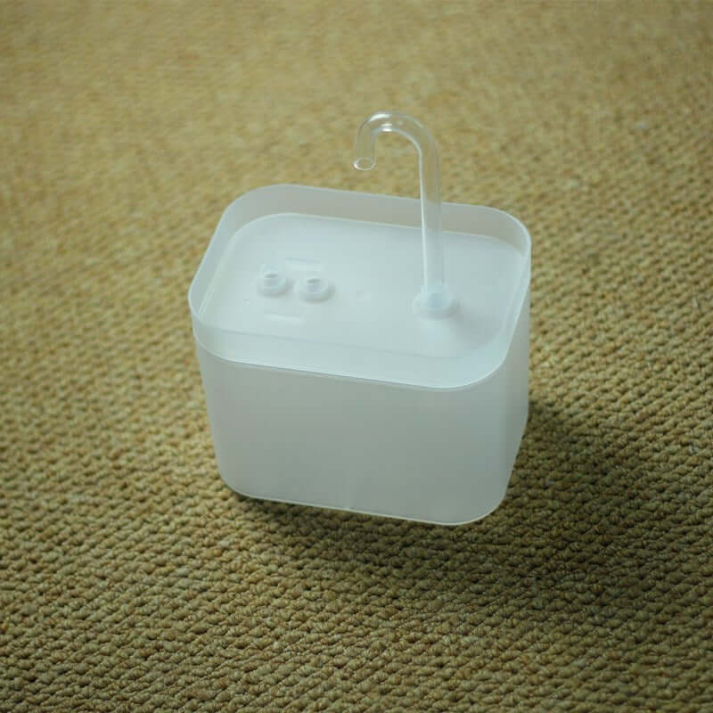 Distributeur automatique d'eau en plastique pour animaux, offrant une source d'eau fraîche et propre.