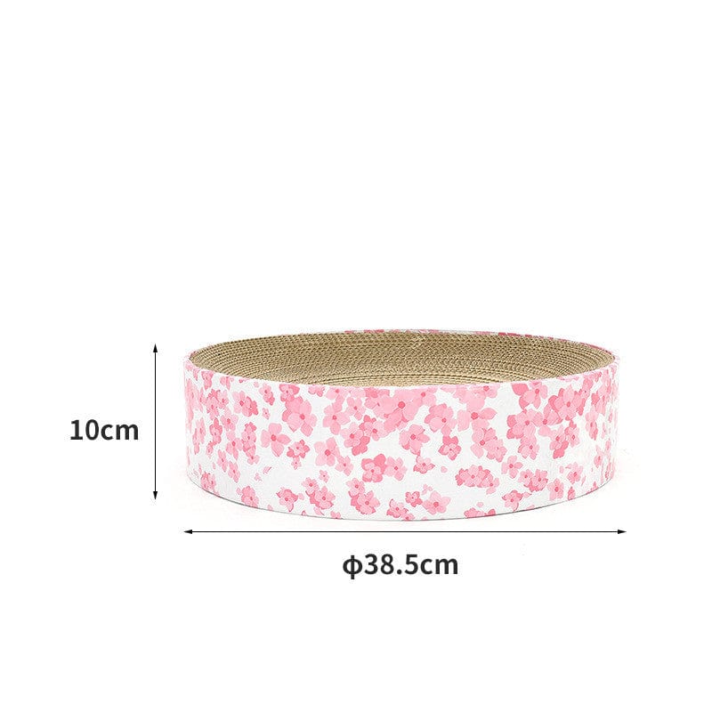 Griffoir rond en carton ondulé pour chat, dimensions 38.5 cm x 10 cm, design fleuri rose pour jouer et gratter.