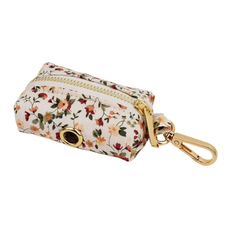 Porte-sac à crottes en coton biologique avec motif floral et fermeture éclair dorée.