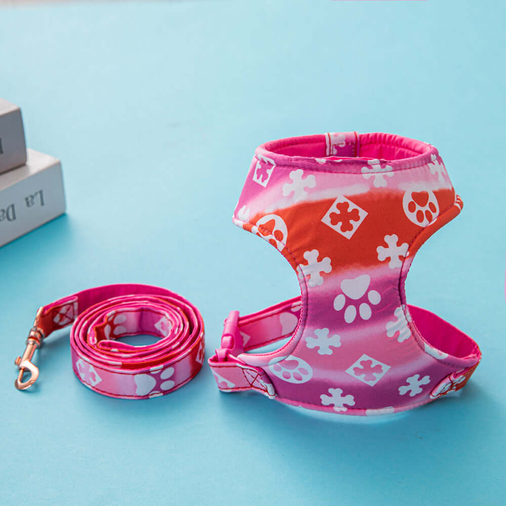 Harnais de traction pour chien en rose et orange avec laisse assortie, idéal pour le confort et le style.