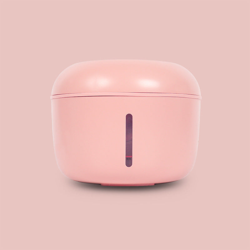 Distributeur d'eau intelligent rose pour chien et chat, 2,5L, design moderne et compact.