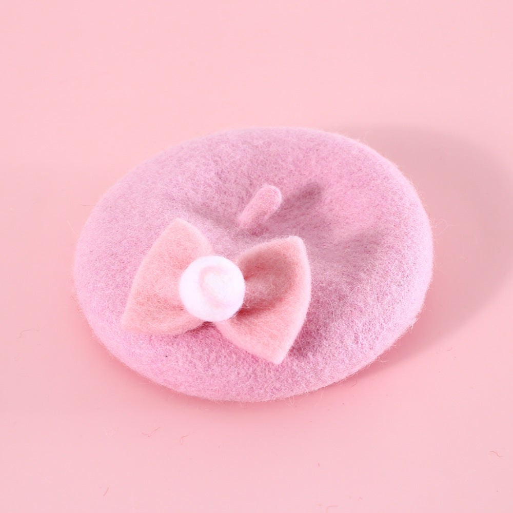 Chapeau en laine rose pour chat avec un nœud décoratif, parfait pour l'hiver et stylé pour les animaux.
