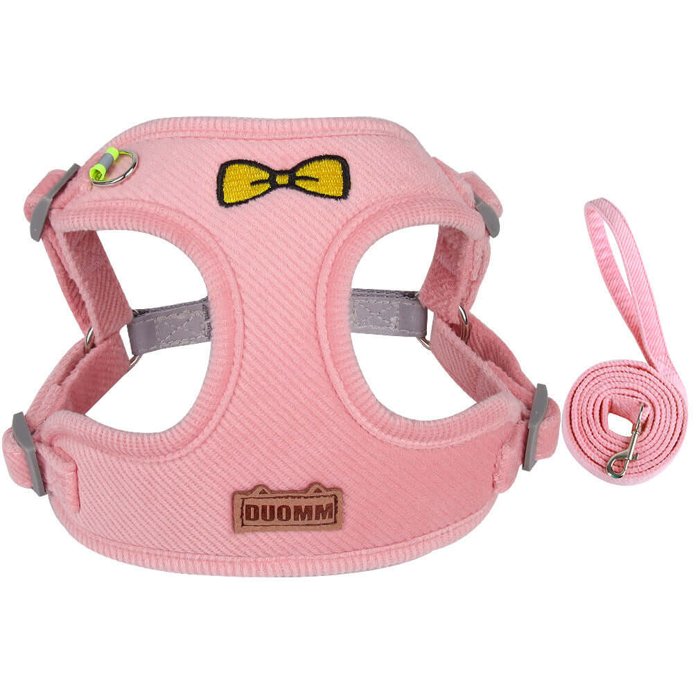 Harnais réfléchissant rose pour chien en corduroy avec sangle de traction et motif de noeud papillon.