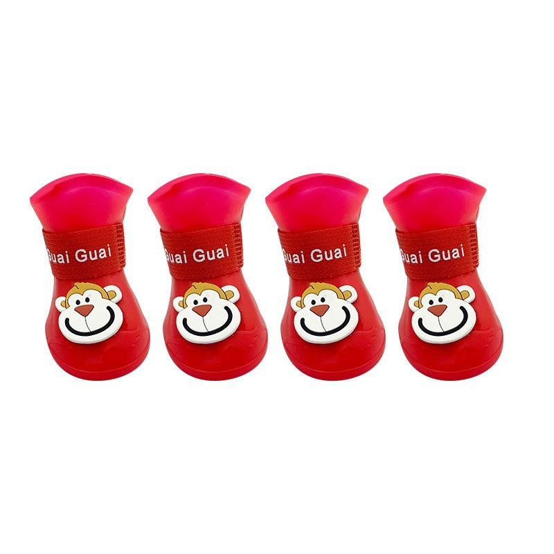 Bottes en silicone rouges pour animaux avec motif de singe, idéales pour protection et confort.