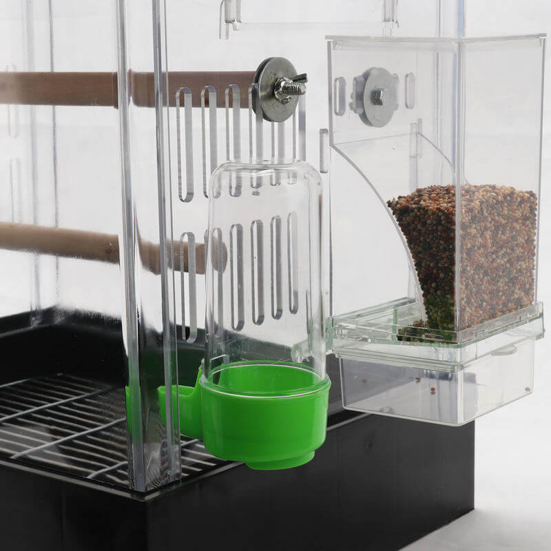 Conteneur transparent automatique pour nourriture d'oiseaux avec distributeur et bol intégré.