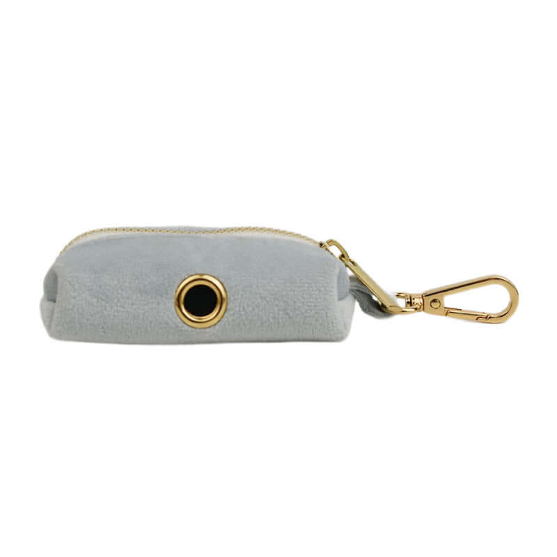 Pet accessory in soft gray velvet with gold zipper and clip, perfect for storing pet essentials.