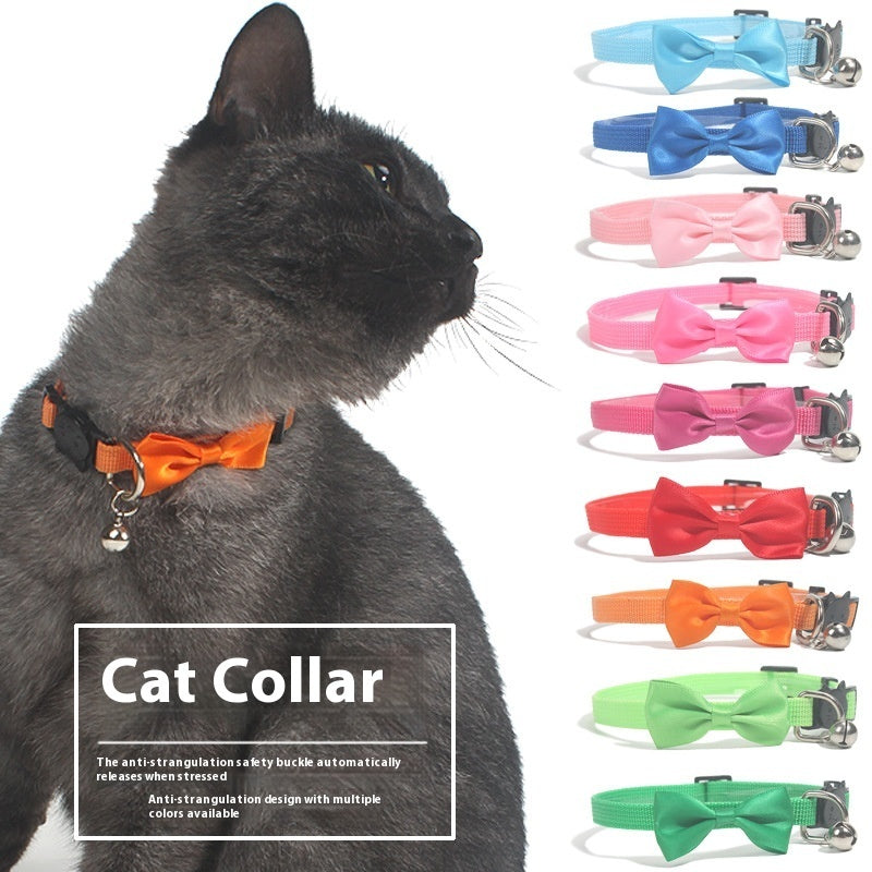 Cat wearing a multi-colored nylon collar with a bow, showcasing various color options and safety features.